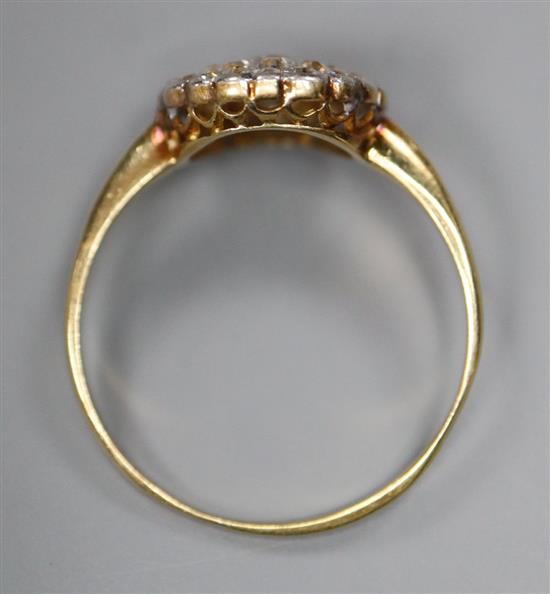 A mid 20th century yellow metal and circular diamond cluster ring, size Q, gross 2.1 grams.